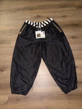 CHANEL Black Jogger Pants with Striped Waistband and Gold Zips